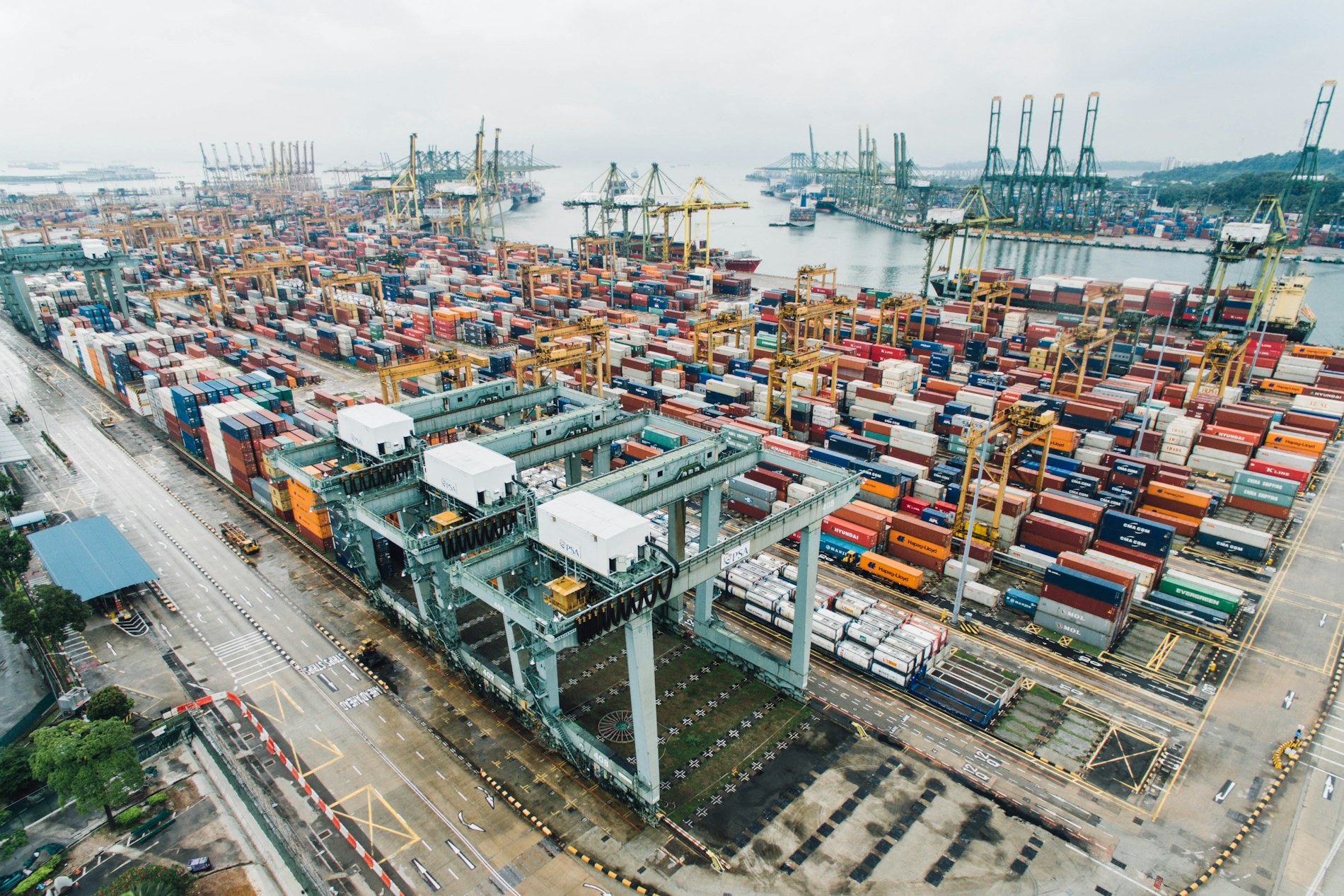 Container cranes, stacked cargo and ships at the port in Bukit Merah, Singapore.